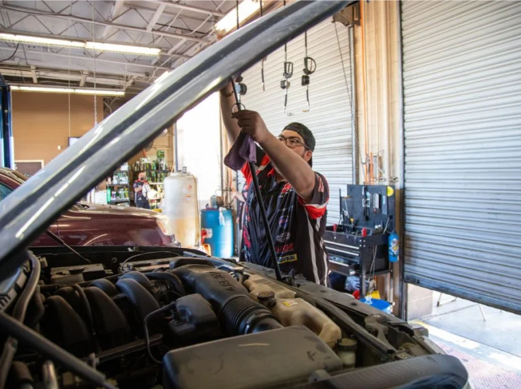 Grease Monkey Phoenix technician working under the hood of a car