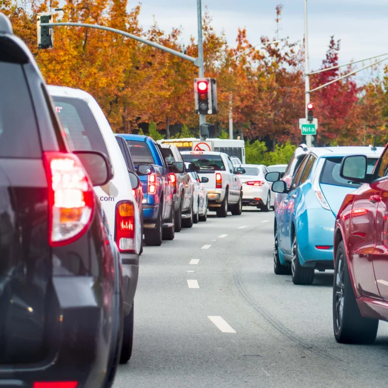 Two lanes of busy traffic on a street.
