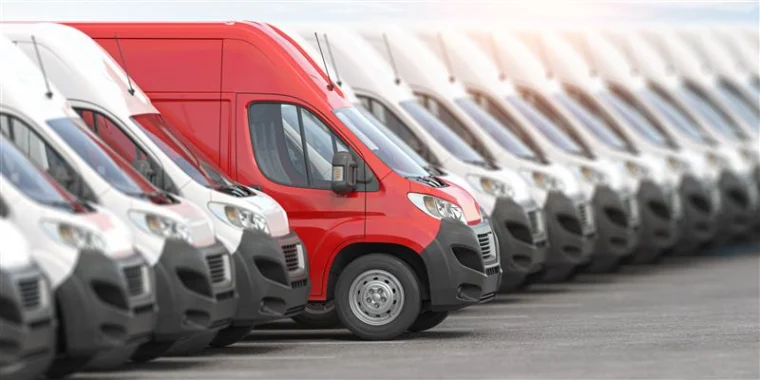 Row of vans parked side by side