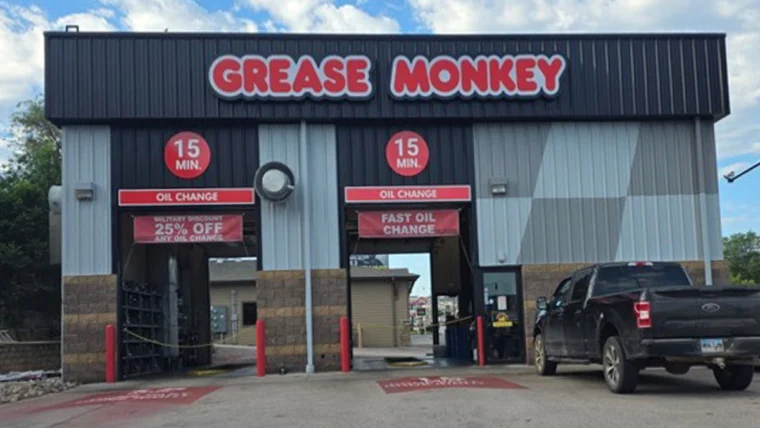 Renovated exterior of Grease Monkey oil change center with updated signage, fresh paint, and modern branding.