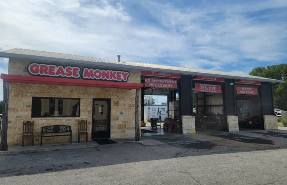 Renovated exterior of Grease Monkey oil change center with updated signage, fresh paint, and modern branding.