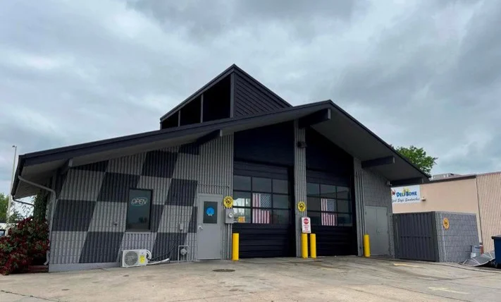 Renovated exterior of Grease Monkey oil change center with updated signage, fresh paint, and modern branding.