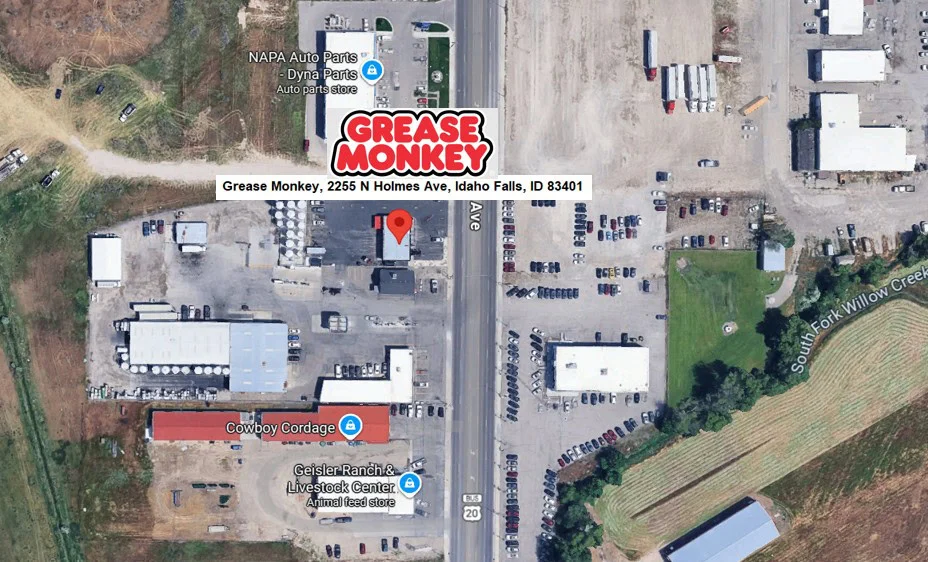 Aerial view of Grease Monkey at 2255 N Holmes Ave, Idaho Falls, ID 83401, showcasing nearby businesses and parking lots—your local destination for expert oil care and engine maintenance. Surrounding roads are clearly visible in this snapshot of Idaho Falls.