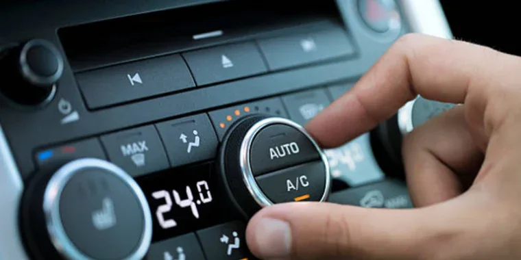 A hand adjusts the Car AC controls on a dashboard, with the temperature set to 24 degrees Celsius—perfect comfort for cruising through Pocatello.