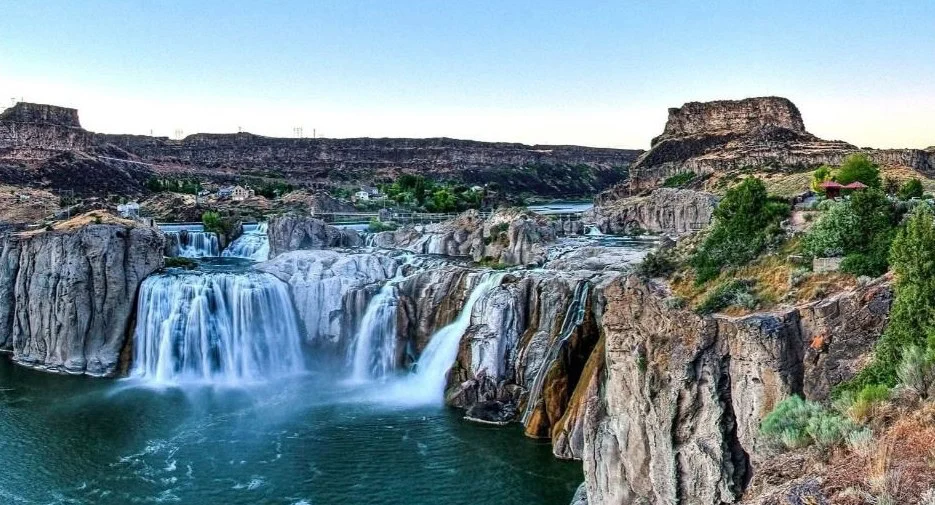 Wide view of Shoshone Falls cascading over rugged cliffs near Twin Falls, where maintaining your Twin Falls engine with a regular oil change is as essential as the flowing river beneath a clear blue sky.