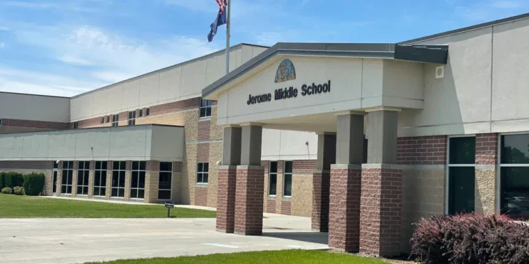 Exterior view of Jerome Middle School building with an American flag and landscaped entrance under a blue sky, located near convenient oil change and vehicle maintenance services in Jerome, Idaho.