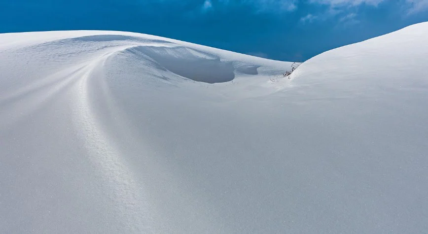 Snow-covered dunes under a bright blue sky remind us that, like the Twin Falls engine, everything runs smoother with a regular oil change.
