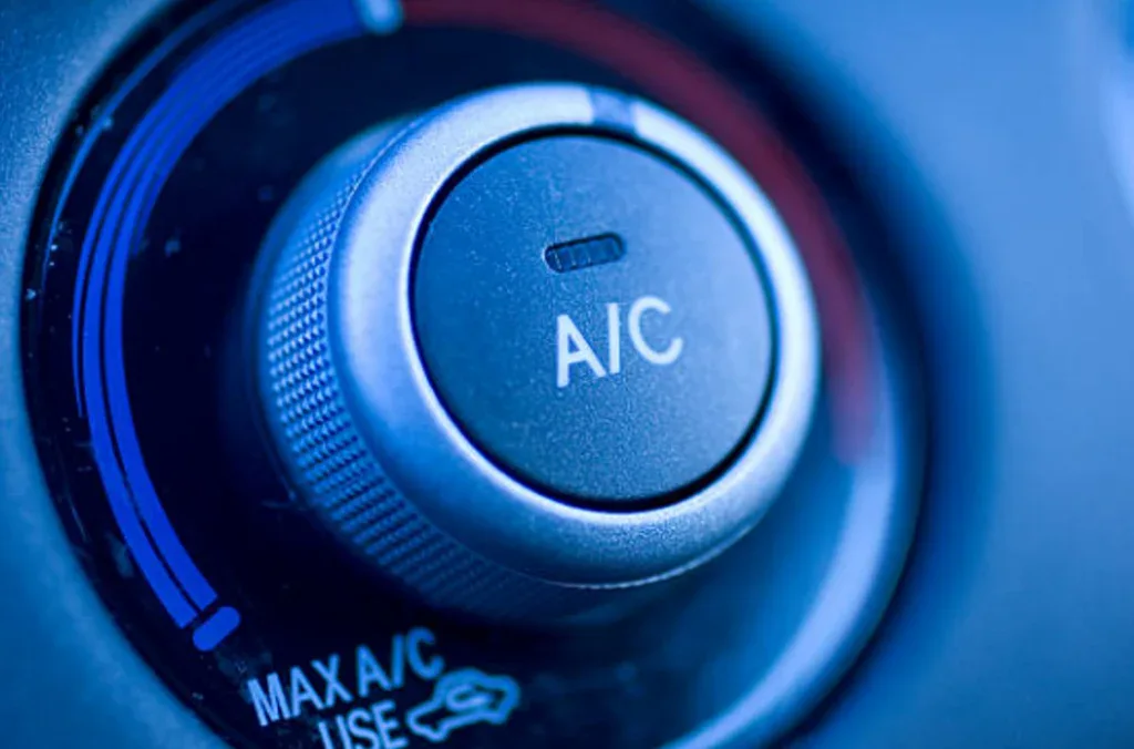 Close-up of a vehicle air conditioning control knob displaying "A/C," surrounded by temperature and fan settings—perfect for those seeking expert air conditioning service in Littleton Colorado.