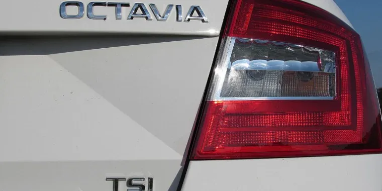 Close-up of the rear section of a white car showing the “OCTAVIA” and “TSI” badges next to the red taillight, highlighting the importance of regular vehicle service and brake system checks in Woodland Park, Colorado.