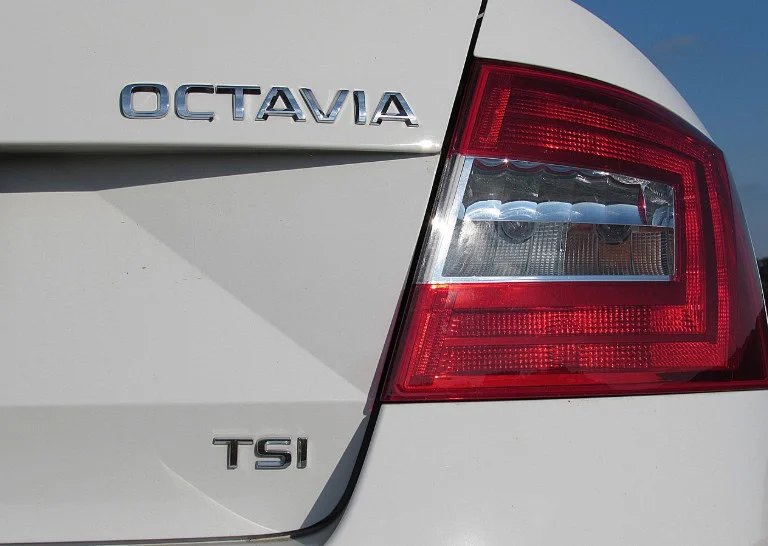 Close-up of the rear section of a white car showing the “OCTAVIA” and “TSI” badges next to the red taillight, highlighting the importance of regular vehicle service and brake system checks in Woodland Park, Colorado.