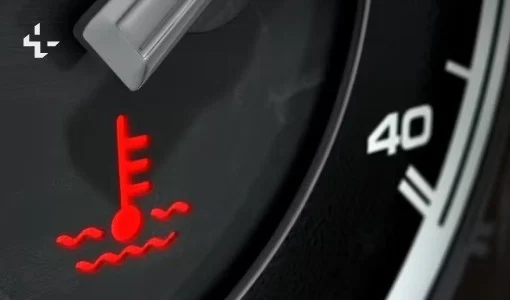 A red engine temperature warning light is illuminated on a car dashboard next to a gauge showing the number 40, a reminder for drivers in Kimberly Idaho—especially when navigating the city’s fastest-growing streets—to monitor both engine and transmission health for safe travels.
