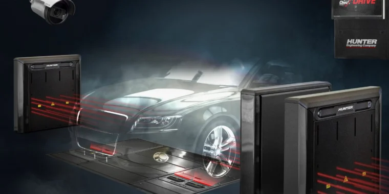 A car drives over a scanning platform surrounded by security sensors, laser beams, and a surveillance camera, illustrating a Quick Check vehicle inspection and alignment system in Idaho Falls.