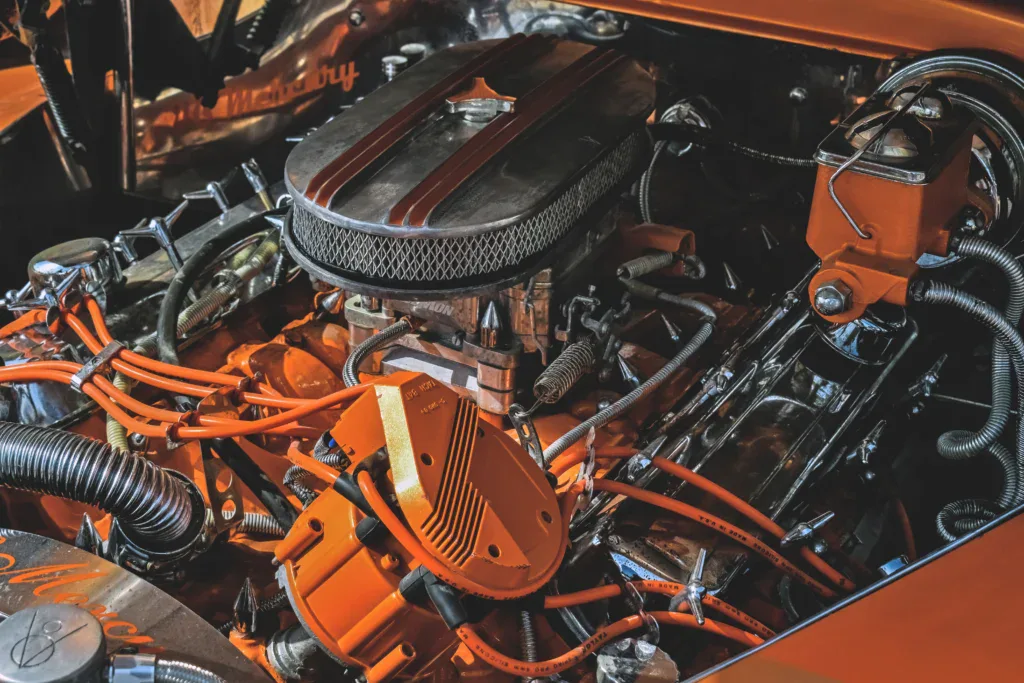 Orange and chrome automotive engine with a large air filter assembly on Yellowstone Avenue.
