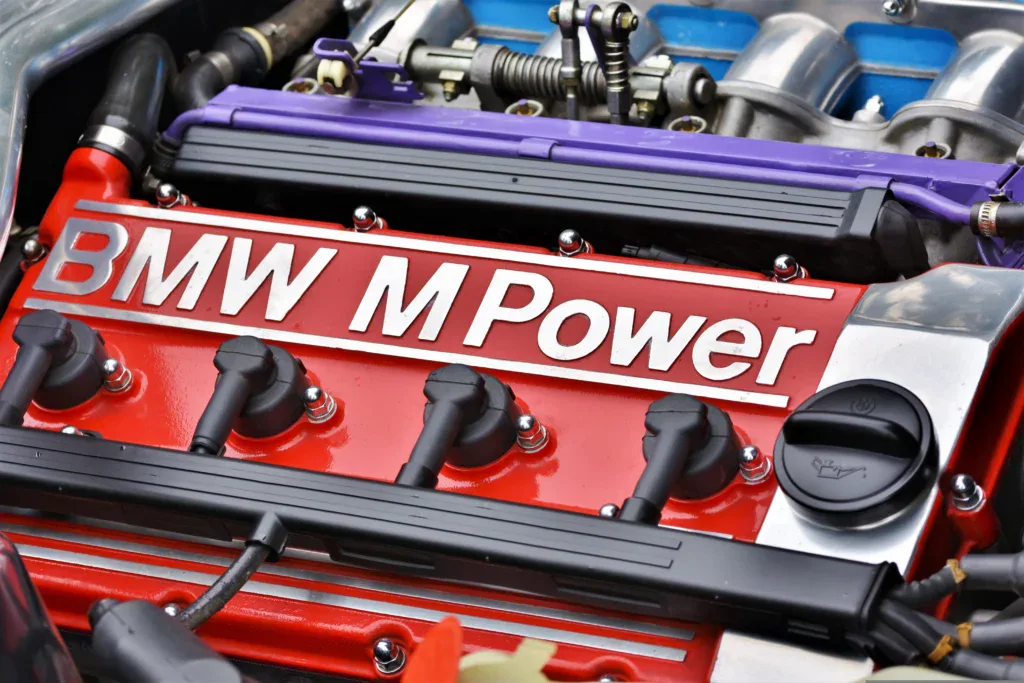 Close-up of a red BMW M Power engine valve cover, representative of high-end performance upgrades.