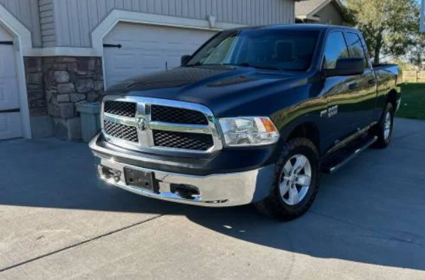 Dark blue Ram 1500 crew cab pickup truck parked in a residential driveway, ideal for those seeking truck performance upgrades.